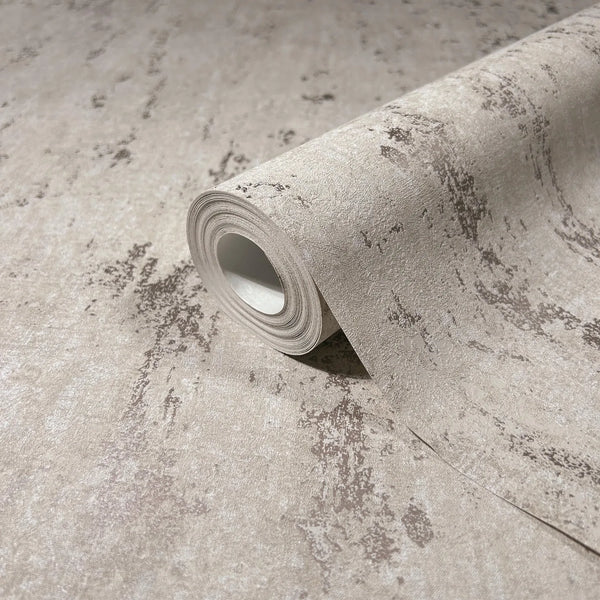 Marburg City Romance 35125 Close-up of a beige wallpaper roll with a mottled, distressed texture, resting on the same pattern.