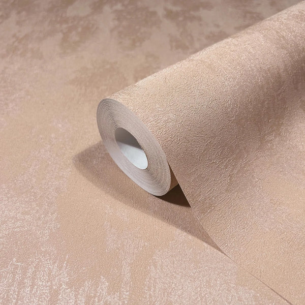 Marburg City Romance 35129 Close-up of a wallpaper roll partially unrolled on a matching sheet, showing a warm peach tone-on-tone textured, lightly mottled finish.
