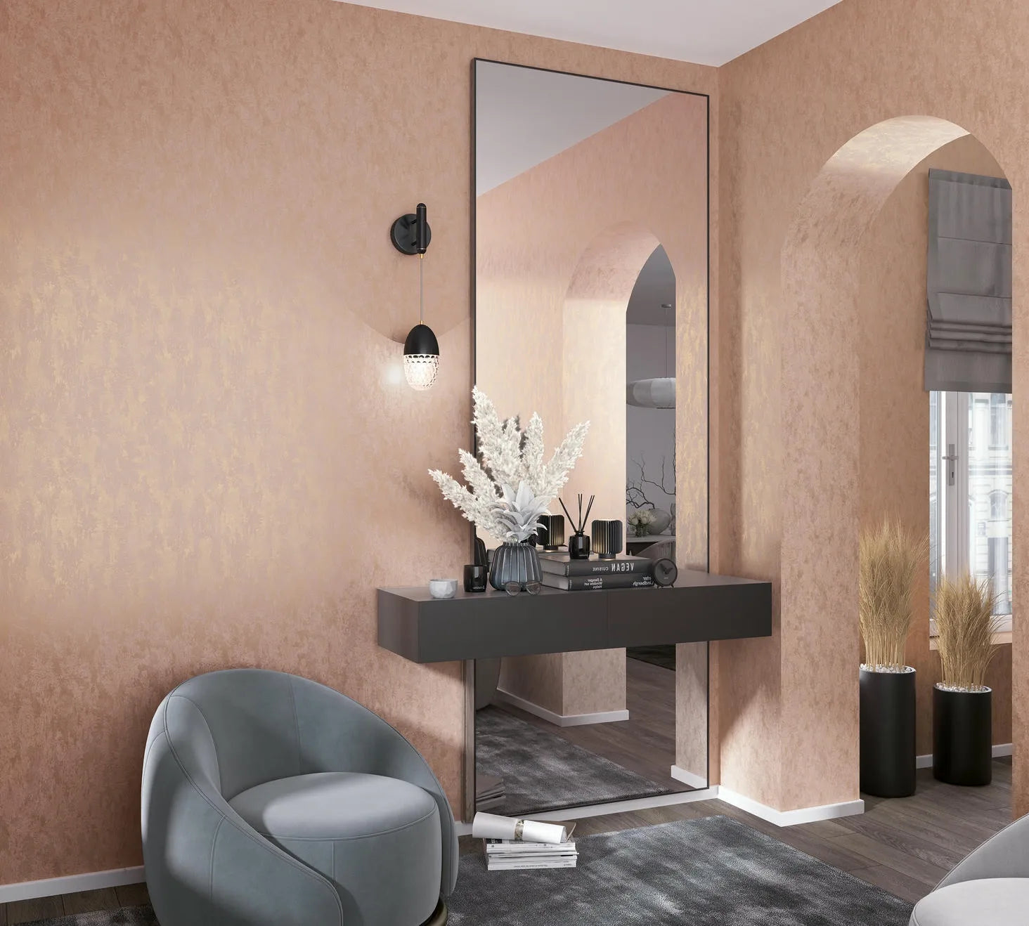 Marburg City Romance 35129 Warm peach wallpaper with a subtle mottled texture covers the walls and archway, shown in an entry area with a wall-mounted console, large mirror, black sconce, gray chair, and black planters with dried grass.