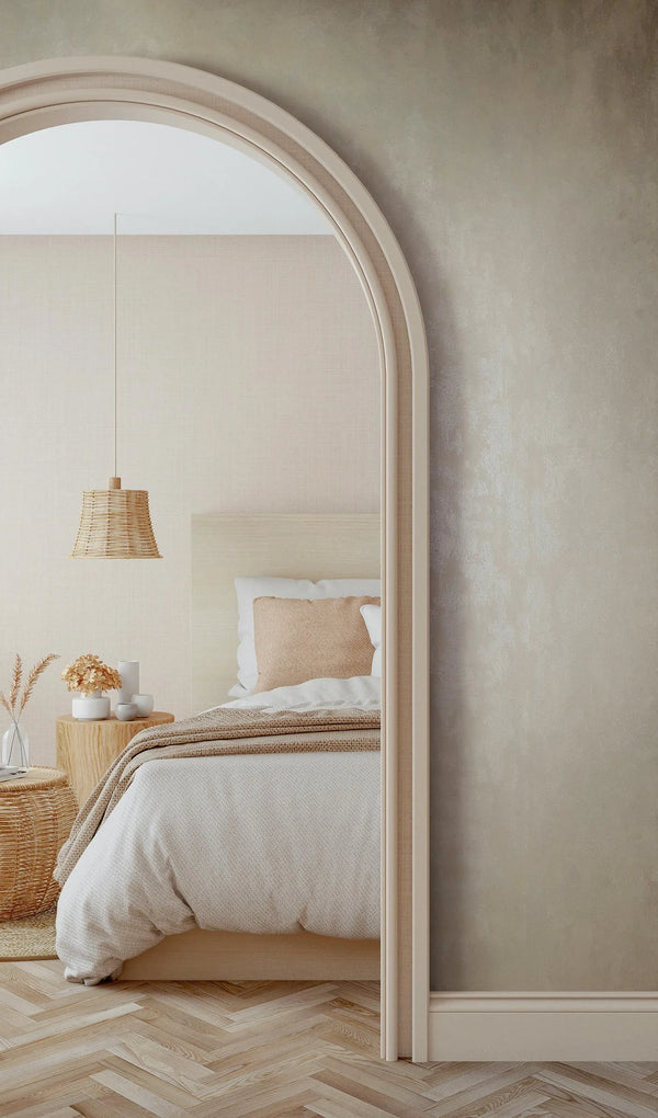 Marburg 35133 wallpaper textured feature wall with arched opening to a serene bedroom with low bed, woven pendant light, wooden bedside table with vases, wicker basket, and herringbone floor for a calm natural mood.