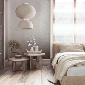 Marburg 35134 wallpaper in a serene bedroom feature wall behind an upholstered bed, wooden side tables with vases and a bonsai, paper lantern pendant, and window blinds.