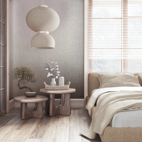 Marburg 35134 wallpaper in a serene bedroom feature wall behind an upholstered bed, wooden side tables with vases and a bonsai, paper lantern pendant, and window blinds.