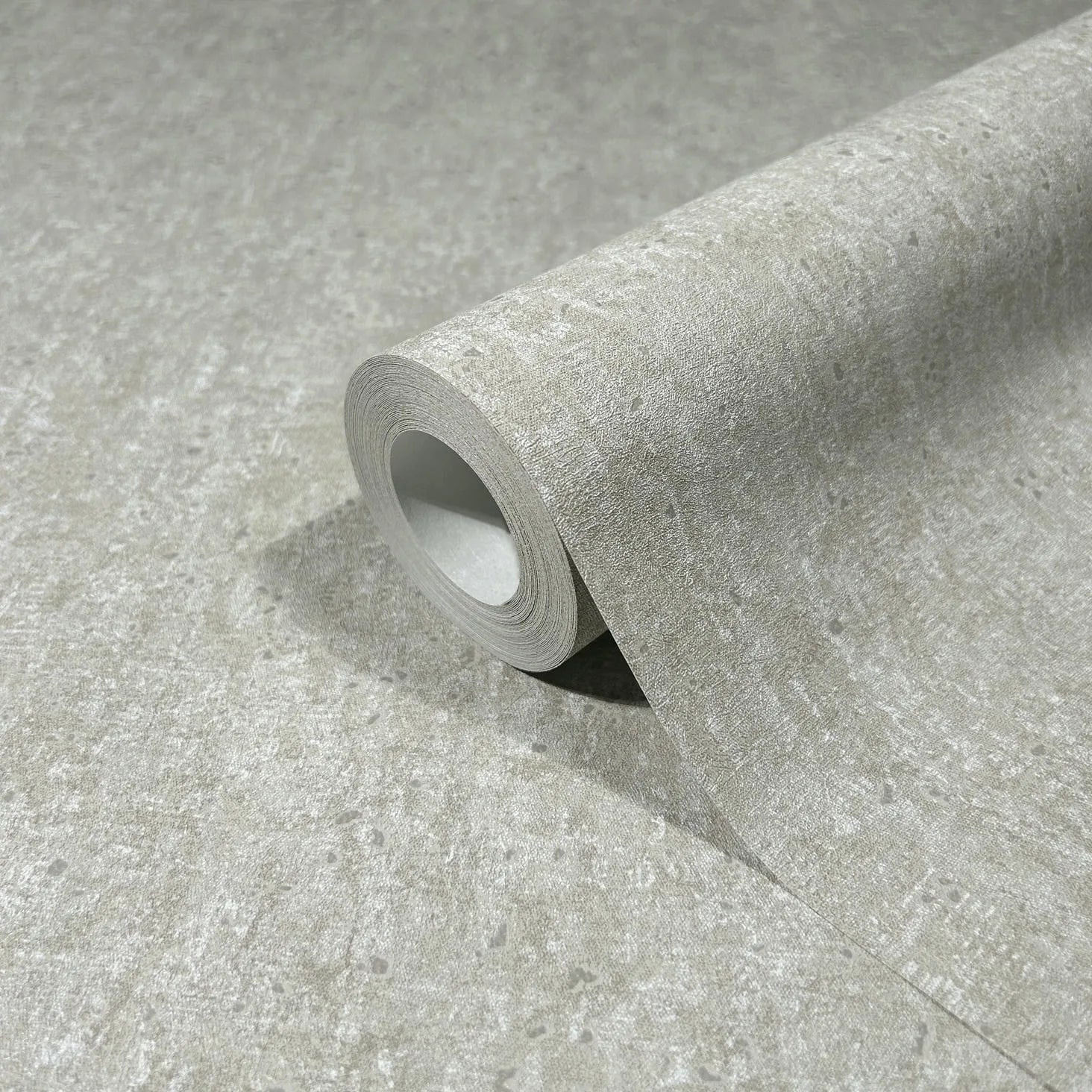 Marburg 35134 wallpaper close-up of textured light gray mottled pattern on a roll.