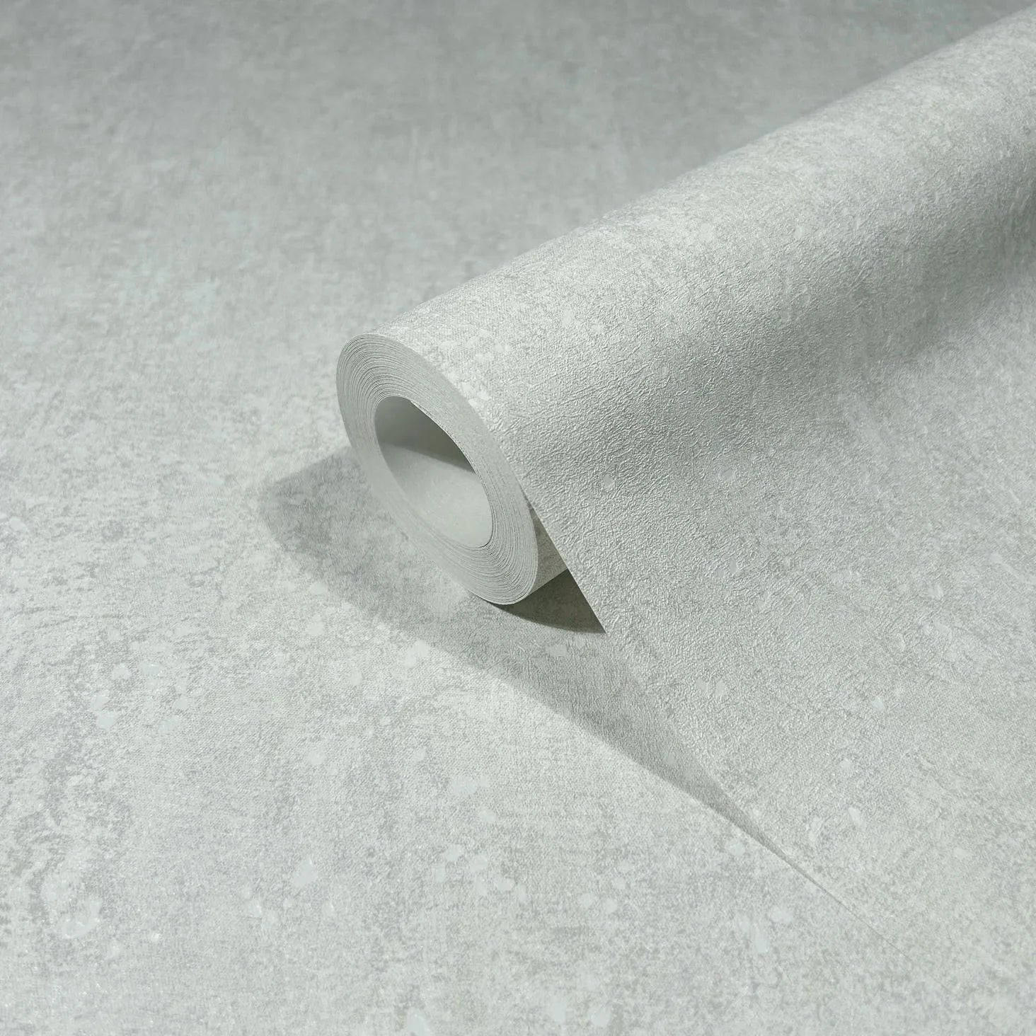 Marburg 35135 wallpaper close-up of a roll showing subtle textured light gray mottled pattern.