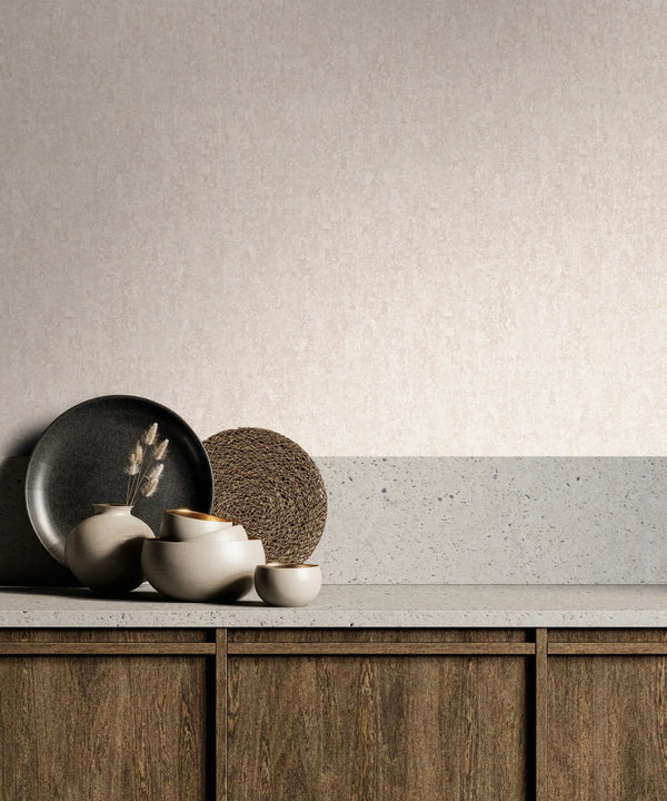 Marburg 35138 wallpaper in a lounge feature wall behind a stone-topped wooden sideboard with ceramic vases holding dried stems, a black platter, and a woven round accent for a calm minimalist mood.