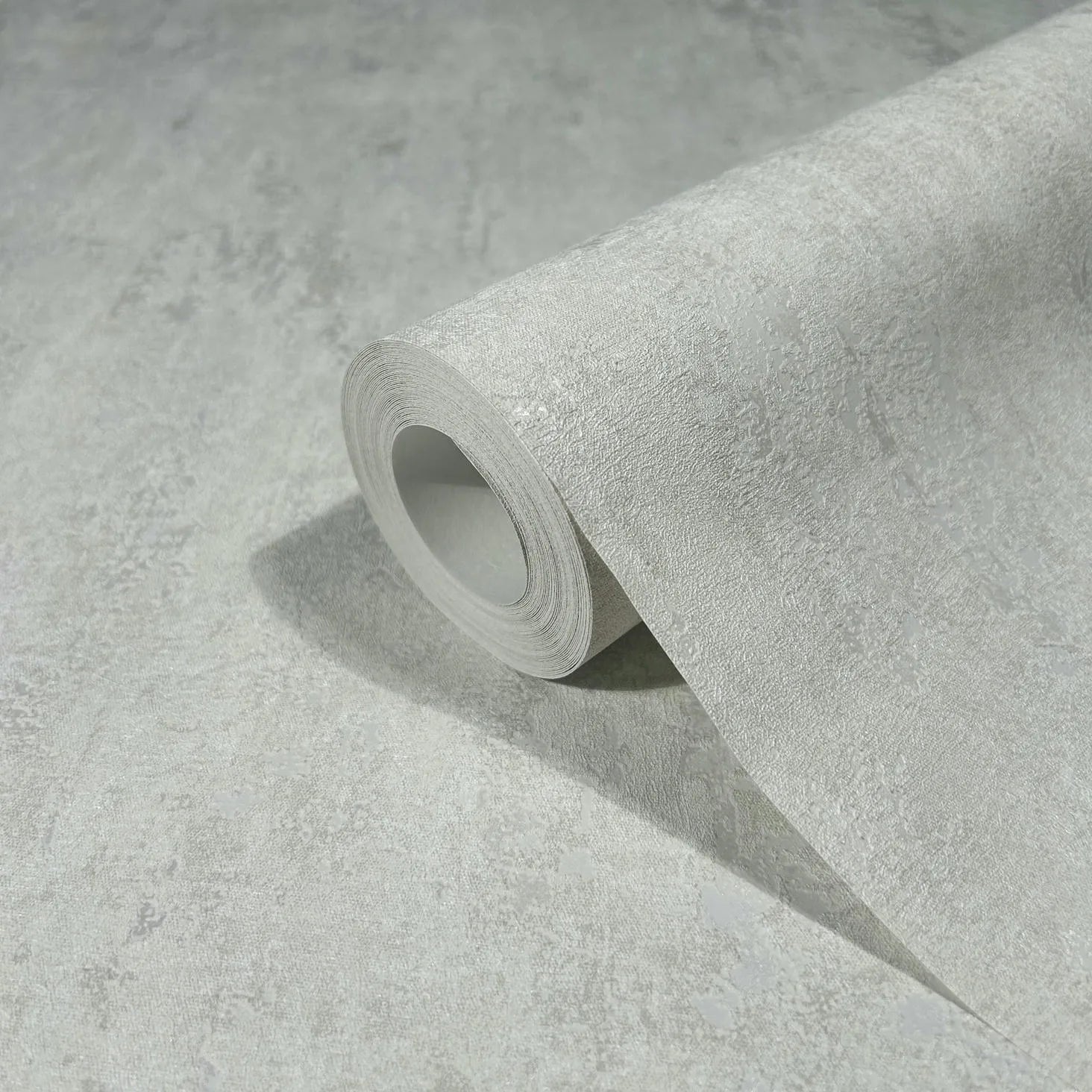 Marburg 35143 wallpaper close-up of rolled sheet with subtle textured light gray concrete look.