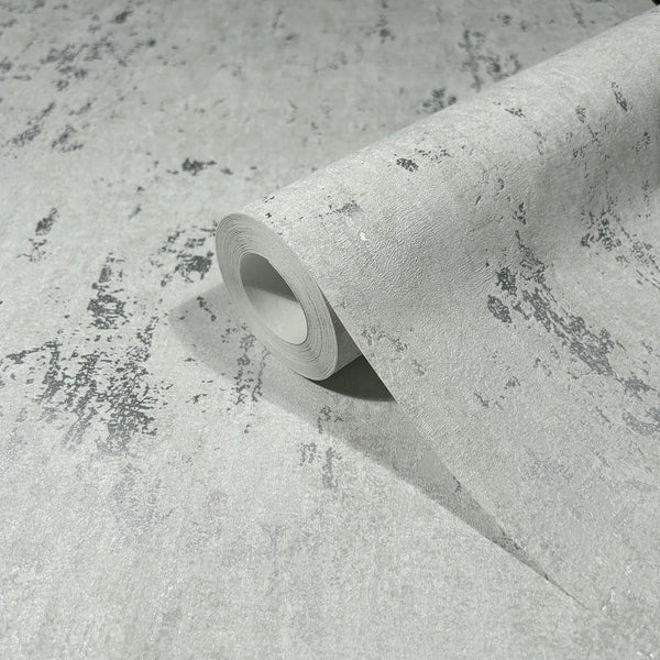Marburg 35144 wallpaper close-up roll with textured concrete-effect pattern and scattered dark speckles.