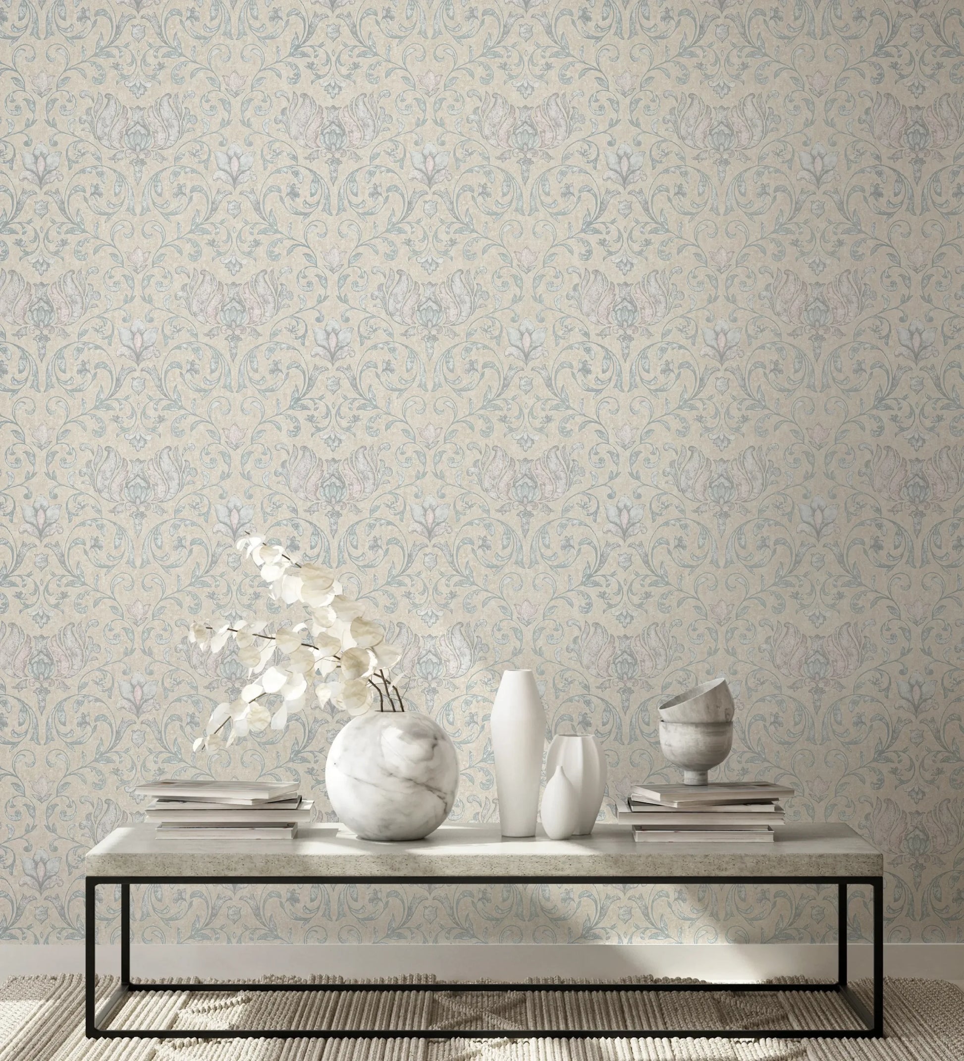 Marburg 35151 wallpaper lounge feature wall behind a minimalist coffee table with marble and white vases, stacked books, and a textured rug for a calm, elegant feel.