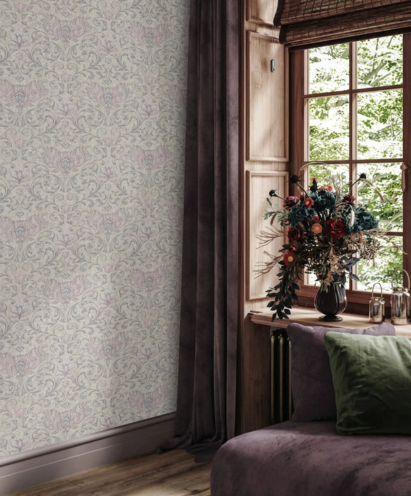 Marburg 35152 wallpaper in a lounge feature wall beside a wood-framed window with woven blind, dark drapes, a plush chaise with a green cushion, and a vase of flowers for a cozy, elegant feel.