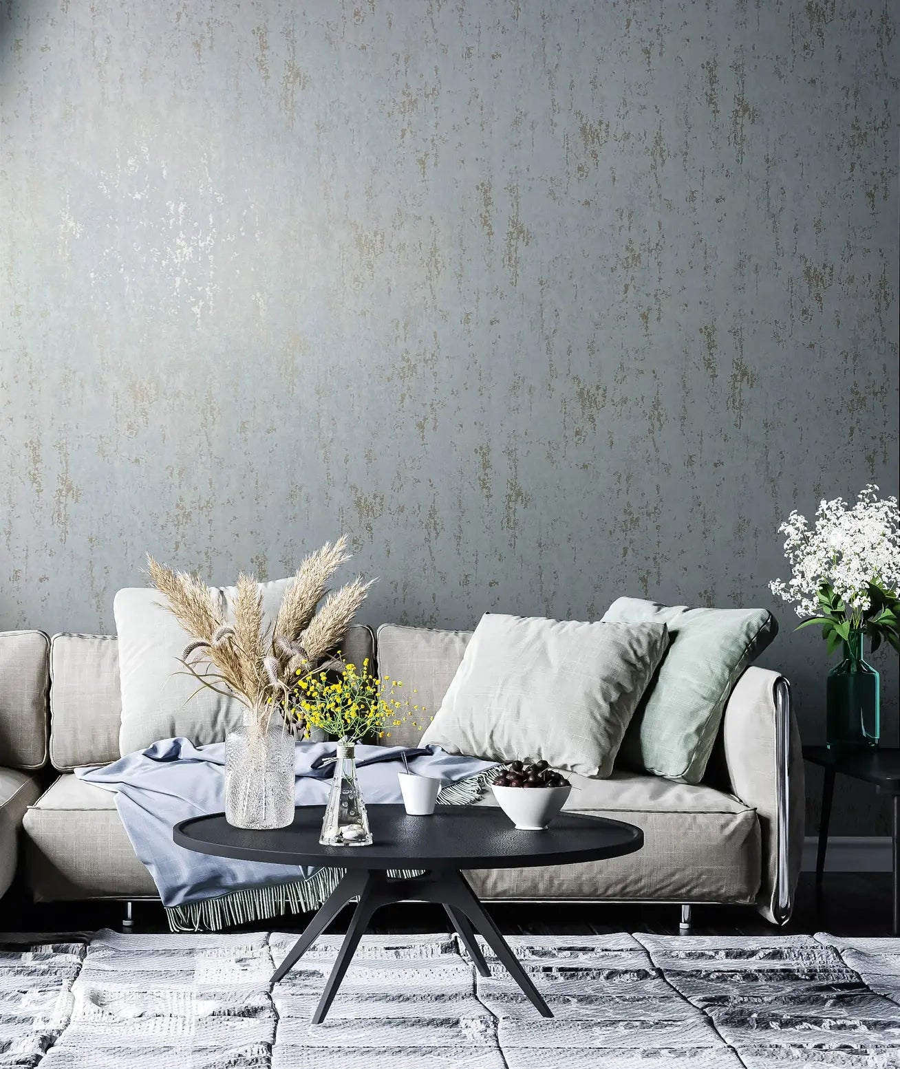 Marburg 35162 wallpaper in a lounge with a textured feature wall behind a cushioned sofa, black round coffee table with vases and pampas grass, side table with flowers, and a calm modern mood.
