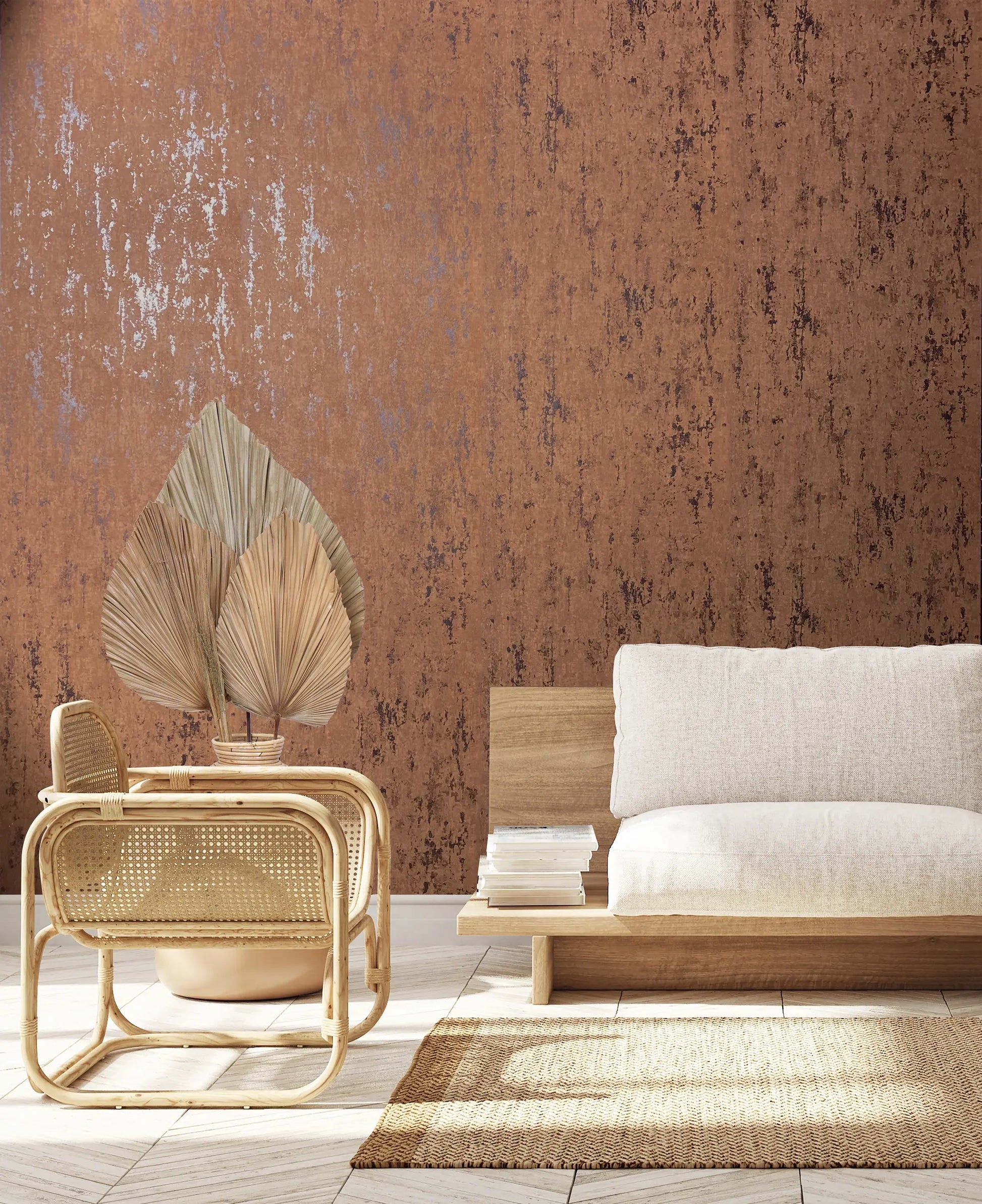 Marburg 35163 wallpaper in a serene lounge with a textured feature wall, low wooden sofa with soft cushions, rattan chair, dried palm leaves, stacked books, and a woven rug.