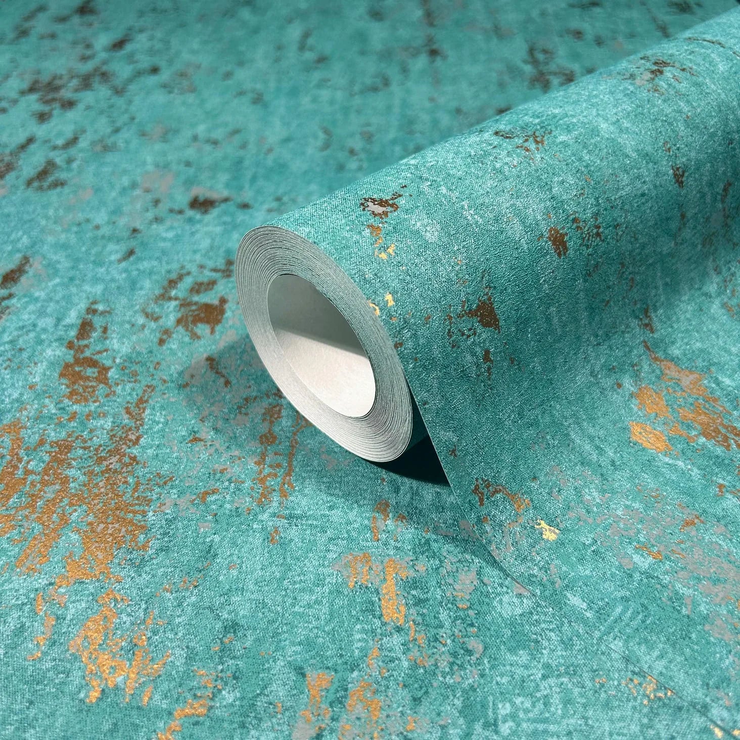 Marburg 35164 wallpaper close-up roll with teal textured surface and distressed metallic gold accents.
