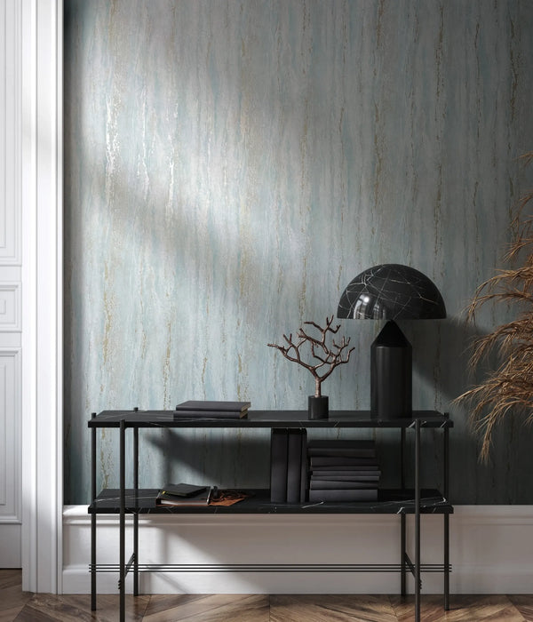 Marburg 35165 wallpaper lounge feature wall with black console table, marble dome lamp, stacked books, branch sculpture, dried grasses, and soft moody light.