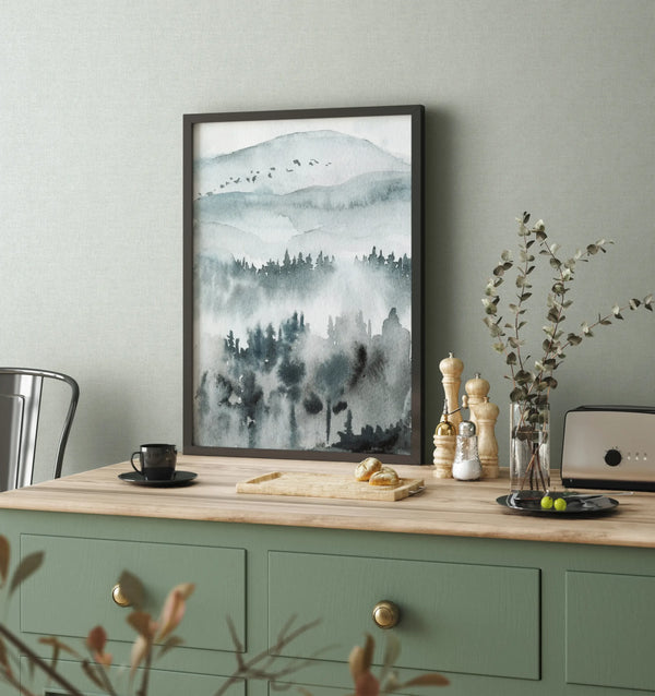 Marburg 47604 wallpaper calm kitchen nook feature wall with framed landscape art, wood-topped cabinet, vase stems, toaster, and coffee cup.