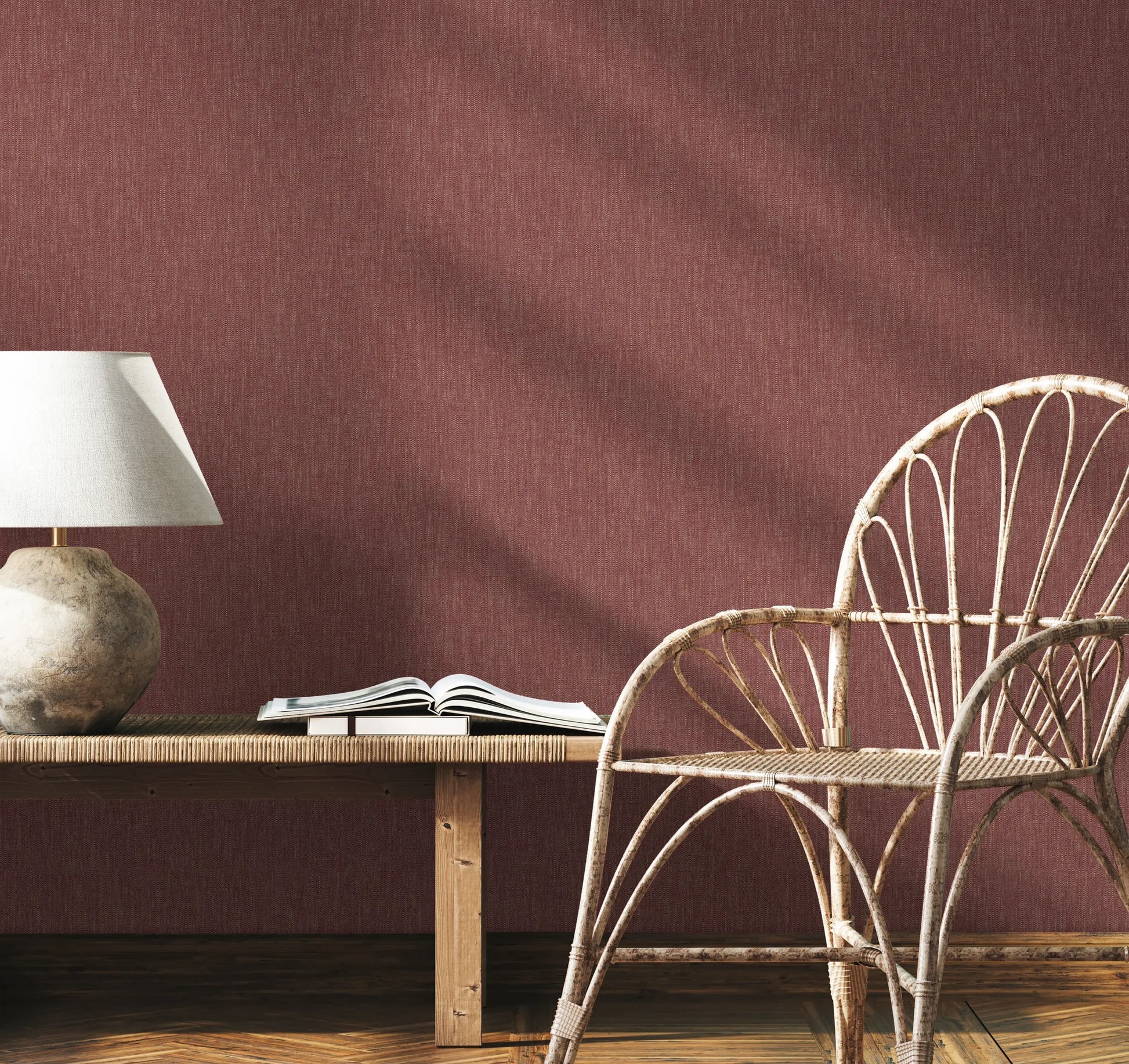 Marburg 47617 wallpaper lounge feature wall behind a rattan chair and wooden bench with a stone table lamp and open book, relaxed and natural.