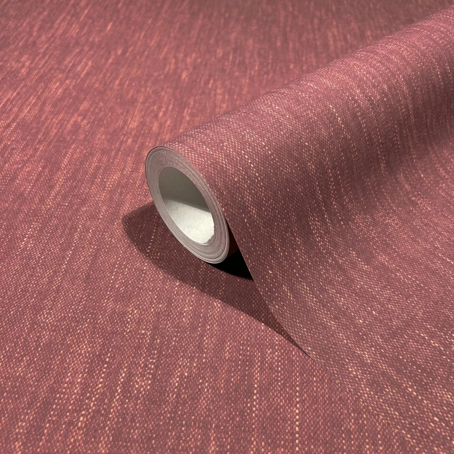 Marburg 47617 wallpaper close-up roll showing textured maroon weave with subtle speckling.