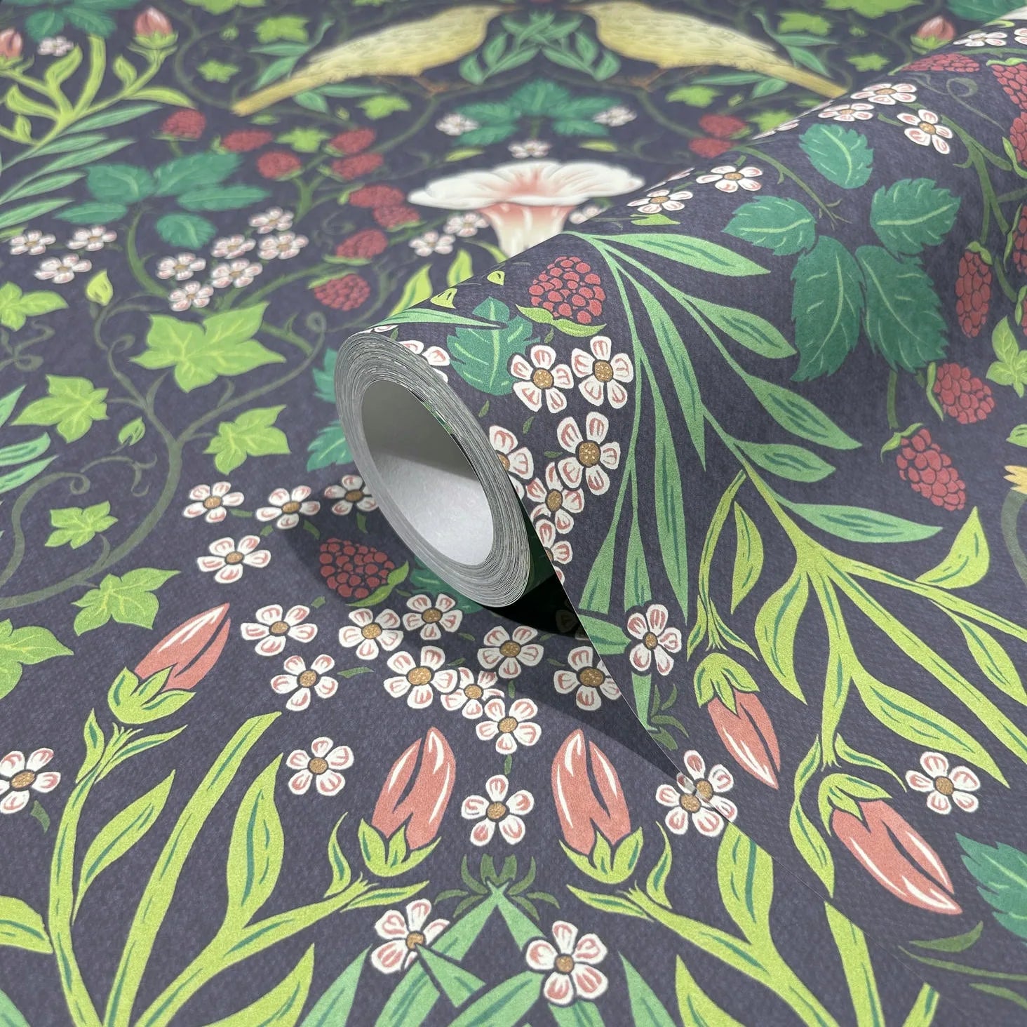 Marburg 47621 wallpaper close-up of botanical pattern with green leaves, berries, and small white flowers on a dark background.