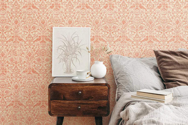 Marburg 47622 wallpaper bedroom feature wall behind wooden bedside table with framed botanical art, white vase and teacup, next to rumpled bed with pillows and books for a cozy mood.