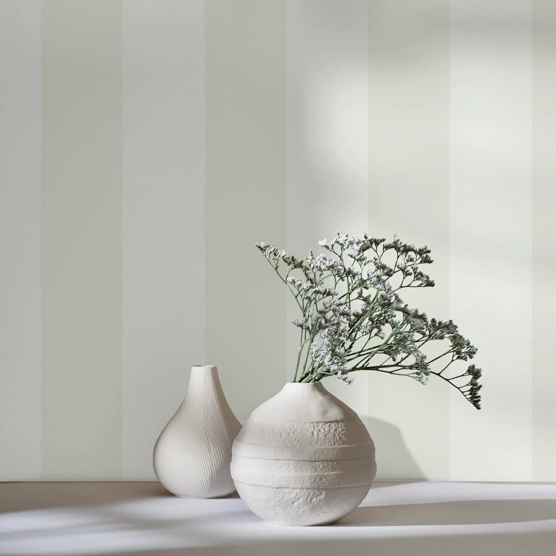 Marburg Heritage 47633 wallpaper with wide beige and green vertical stripes and a soft linen-like texture.