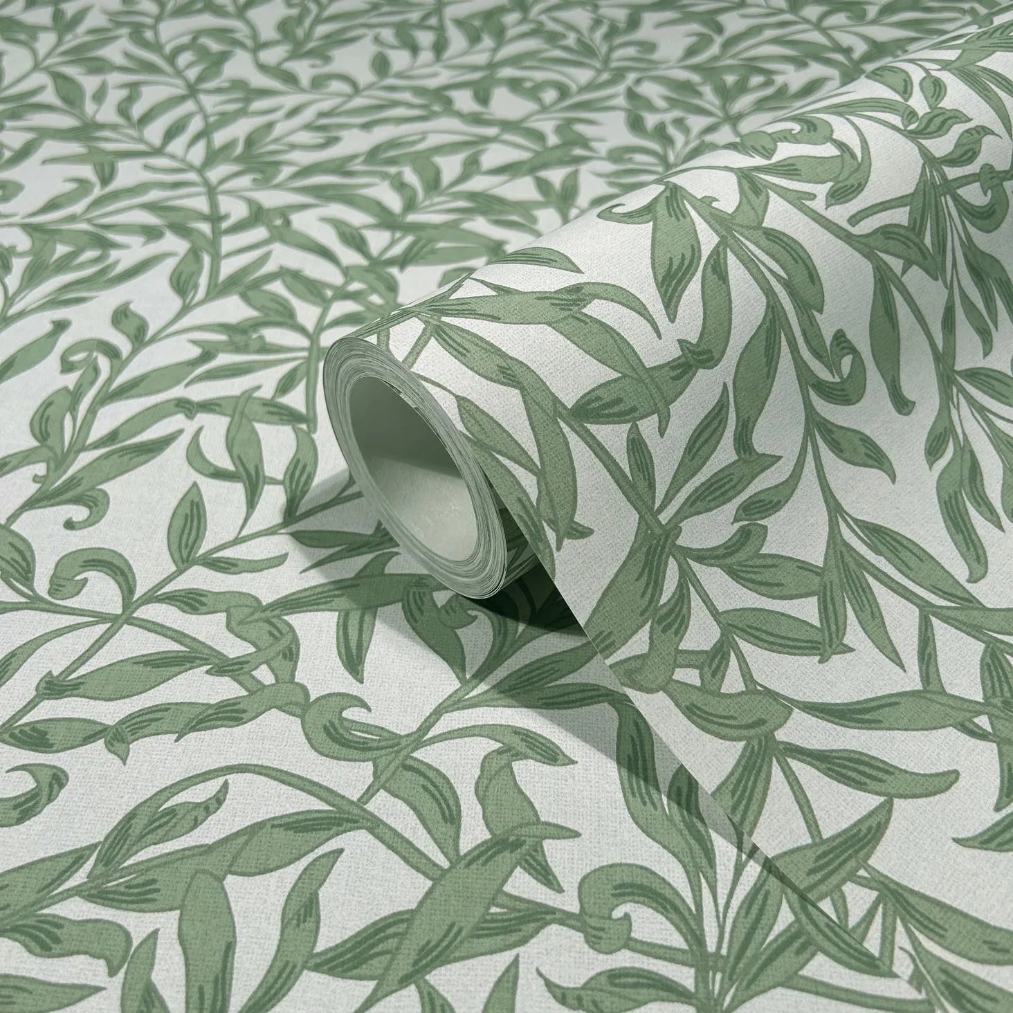 Marburg 47640 wallpaper close-up of green leafy vine pattern on a light background with a partially unrolled roll.