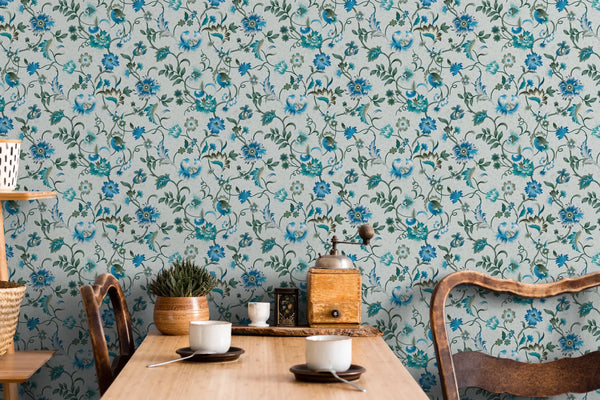 Marburg 47647 wallpaper dining feature wall behind a wooden table with rustic chairs, potted plant, vintage coffee grinder and cups, cozy rustic mood.