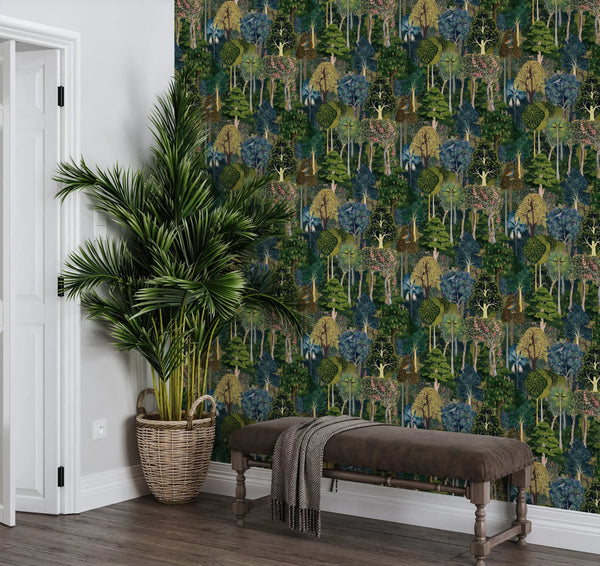 Marburg 47650 wallpaper lounge feature wall with dense forest pattern, upholstered bench with throw, wicker-basket palm, relaxed natural vibe.