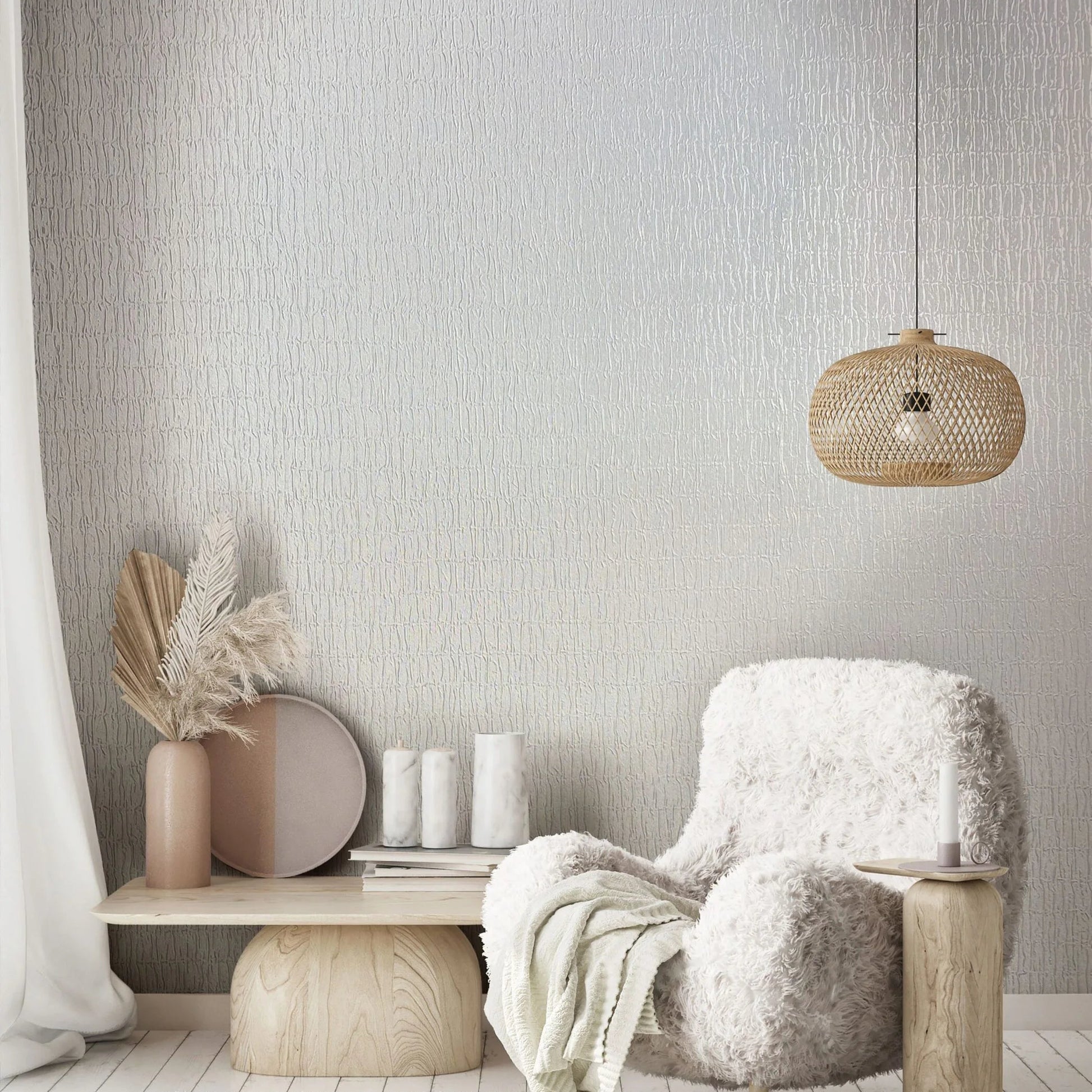 Marburg Kumano 34501 Textured white wallpaper with irregular vertical lines behind a shaggy armchair, a woven rattan pendant light, and a low wood bench with decor.