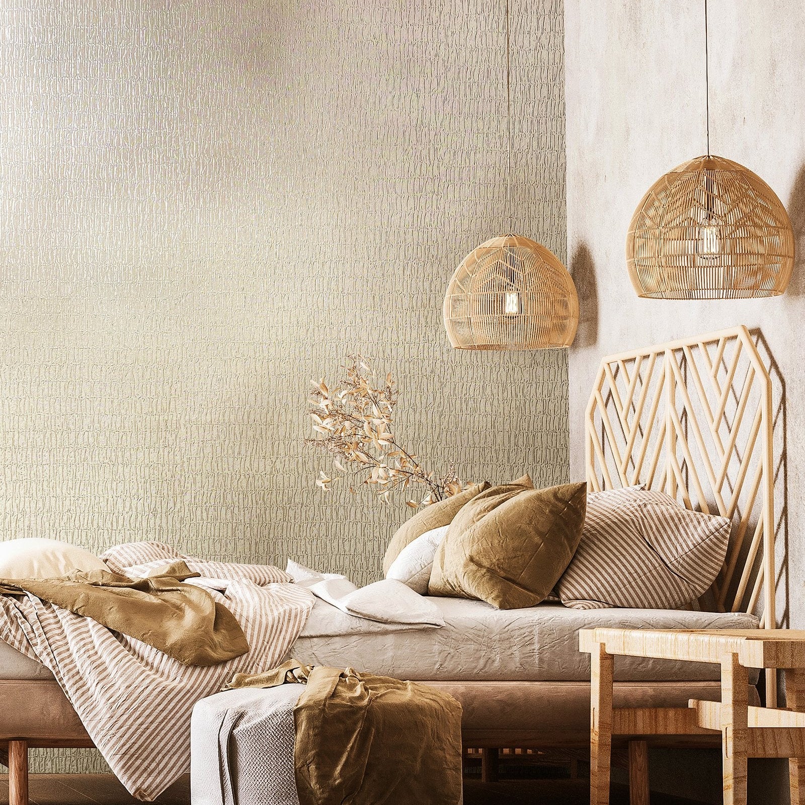 Marburg Kumano 34502 Bedroom scene featuring light beige-gray textured wallpaper with an organic crackle pattern behind a low bed with a wood geometric headboard, two rattan pendant lights, a small bench, and layered bedding.