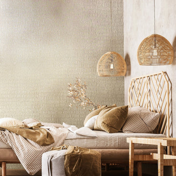 Marburg Kumano 34502 Bedroom scene featuring light beige-gray textured wallpaper with an organic crackle pattern behind a low bed with a wood geometric headboard, two rattan pendant lights, a small bench, and layered bedding.