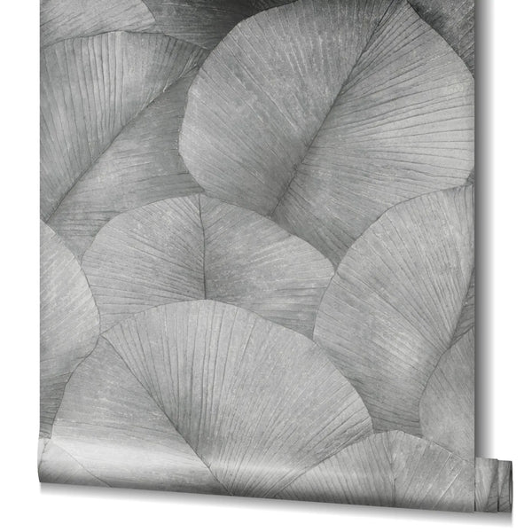 Marburg Kumano 34508 Partially unrolled wallpaper roll showing a gray pattern of overlapping fan-like leaves with fine veins, with the roll visible at the lower right edge.
