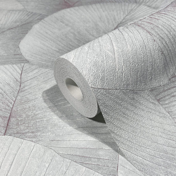 Marburg Kumano 34512 Close-up of a wallpaper roll resting on matching wallpaper showing a large overlapping leaf pattern with textured veins in light gray.