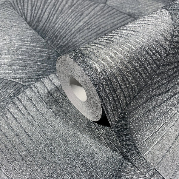 Marburg Kumano 34514 Close-up of a silver and dark gray wallpaper roll resting on matching unrolled wallpaper, showing a raised curved linear texture with fan-like segments.