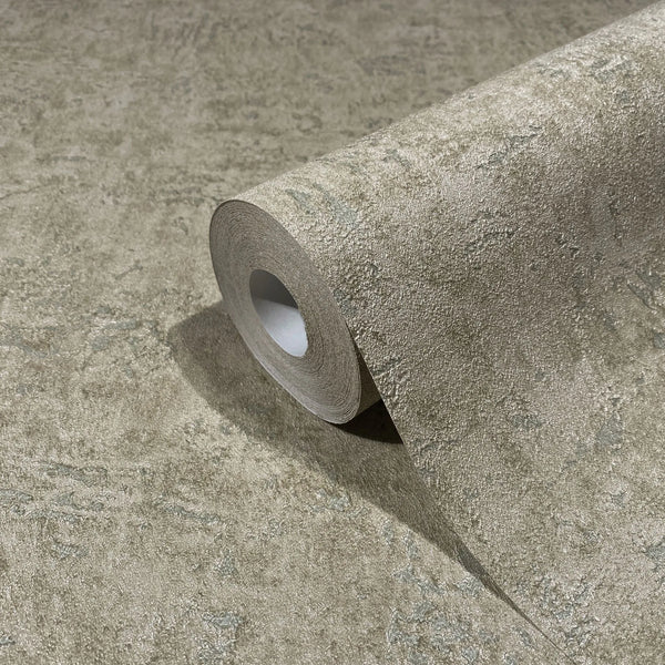 Marburg Kumano 34522 Close-up of a wallpaper roll resting on matching wallpaper, showing an abstract mottled texture in earthy brown with subtle green tones.