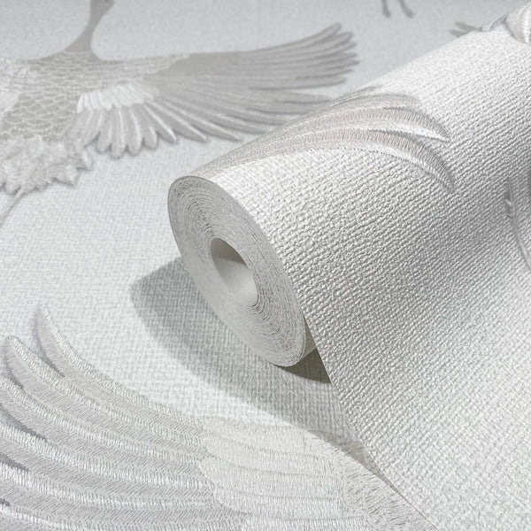 Marburg Kumano 34528 Close-up of a wallpaper roll on the same design, showing a textured white ground with tonal raised crane wings and feathers.
