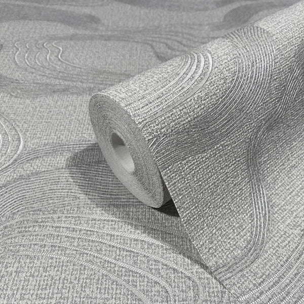 Marburg Kumano 34536 Gray wallpaper roll with a raised wavy line pattern on a textured background, shown resting on matching unrolled wallpaper.
