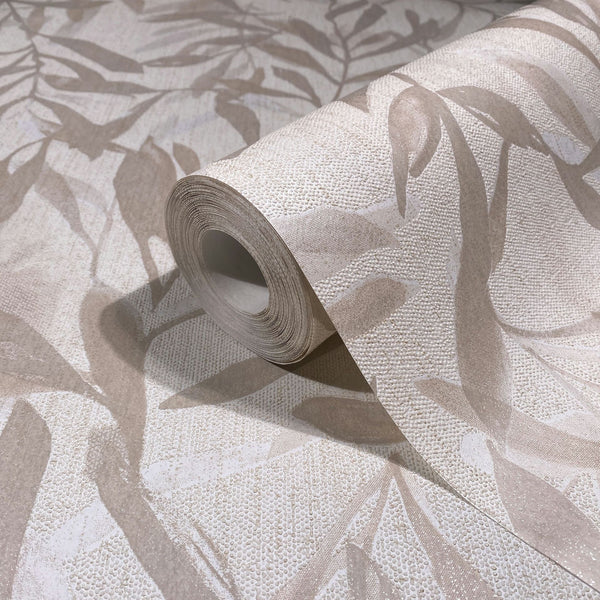 Marburg Leyla 82441 Close-up of a wallpaper roll with a beige and off-white leaf motif and pebbled texture, shown resting on the same unrolled pattern.