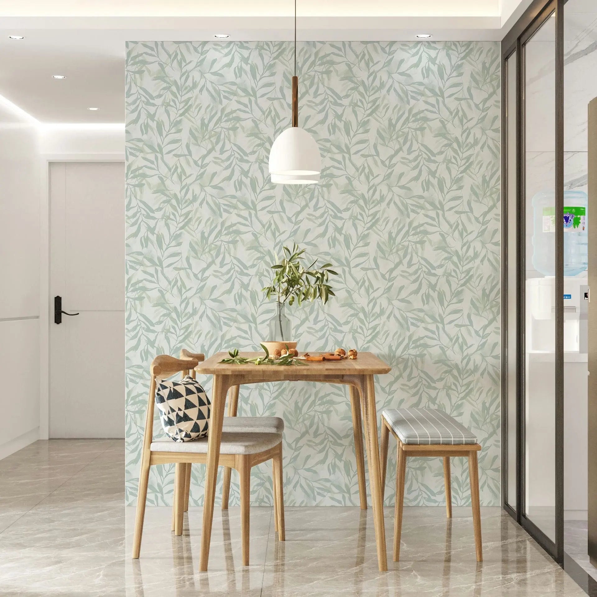 Marburg Leyla 82442 Leafy green-on-white wallpaper behind a small wooden dining set with a pendant light and a potted plant.