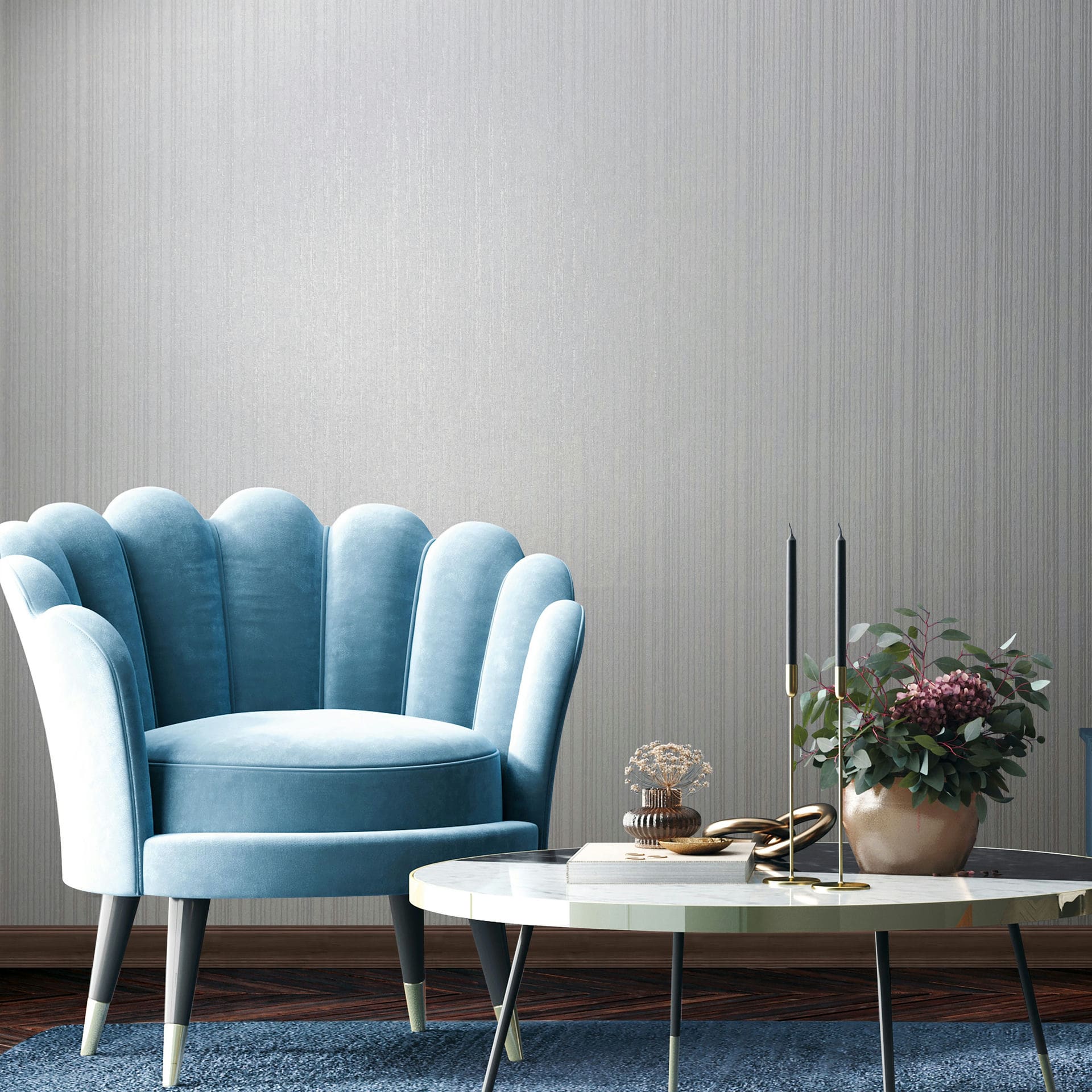 Marburg Leyla 82445 Light grey wallpaper with fine vertical strié texture behind a blue scalloped armchair and a round coffee table with black candles and a potted plant.