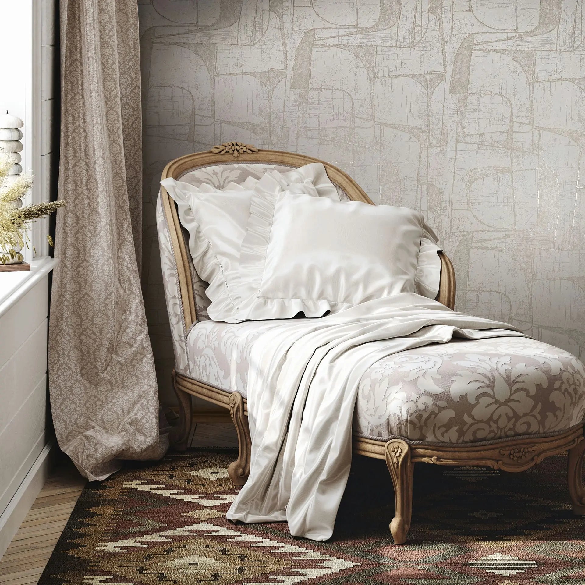 Marburg Leyla 82450 Light beige abstract geometric wallpaper behind a carved chaise with white pillows and a draped blanket beside a window with a patterned curtain and a woven rug.