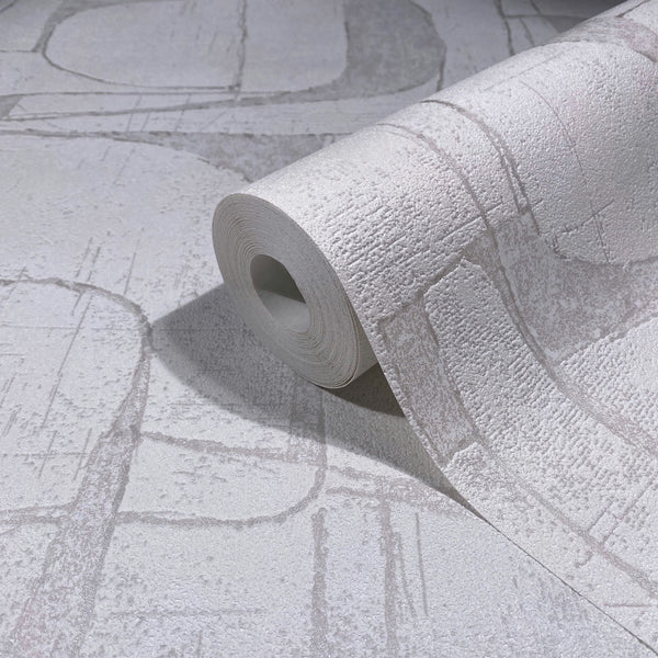 Marburg Leyla 82451 Close-up of a wallpaper roll resting on matching white and light gray abstract textured wallpaper with curved and linear shapes.