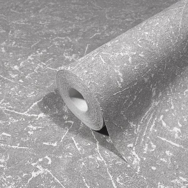 Marburg Loft Superior 34155 Close-up product photo of a wallpaper roll with a gray, distressed marbled pattern, partially unrolled on the same wallpaper.