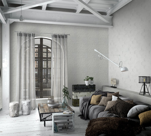 Marburg Loft Superior 34157 Subtle light neutral hexagon-pattern wallpaper on the right wall paired with whitewashed brick‑look, wallpaper on a living room feature wall.