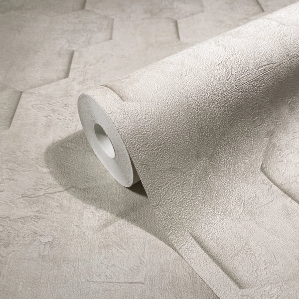 Marburg Loft Superior 34158 Close-up of a beige embossed wallpaper roll resting on matching unrolled wallpaper, showing a subtle plaster-like texture.