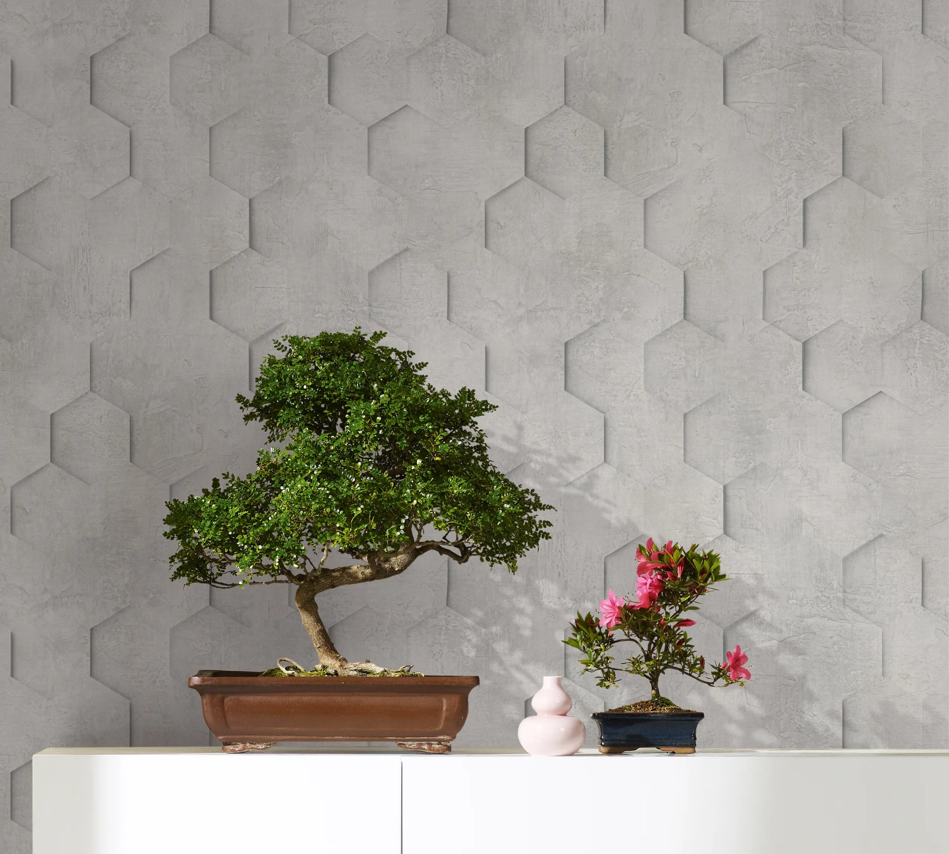 Marburg Loft Superior 34159 Light gray geometric hexagon motif with a subtle concrete-look texture and a shadowed 3D effect wallpaper shown in a styled detail.
