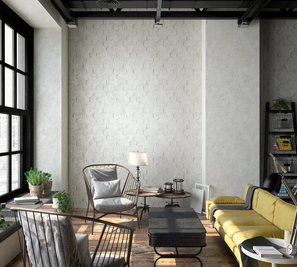Marburg Loft Superior 34159 Industrial living room with a light gray hexagon-pattern wallpaper on the main wall, large black-framed windows, a yellow sofa, metal-frame lounge chairs, a black coffee table, side tables with a lamp, plants, and a ladder bookshelf.