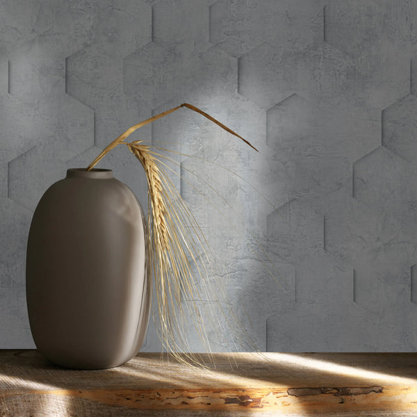 Marburg Loft Superior 34160 Close-up of gray geometric textured wallpaper behind a matte vase holding dried wheat on a rustic wood shelf with light and shadow.
