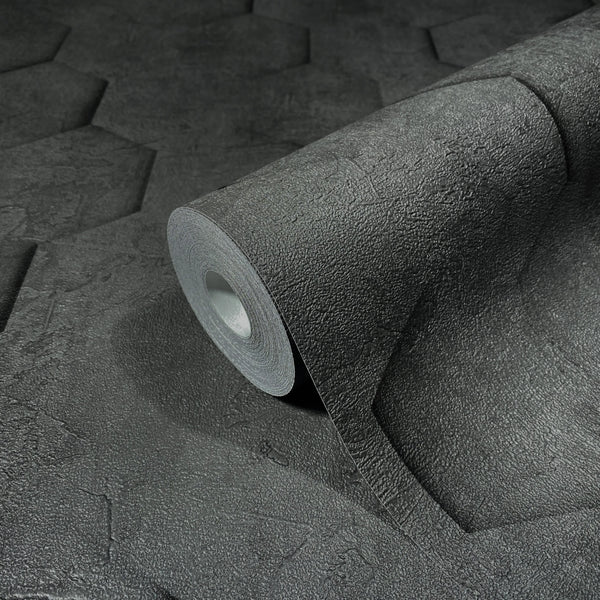 Marburg Loft Superior 34161 Close-up of a dark charcoal wallpaper roll on matching material, showing a rough texture with large embossed hexagon shapes.