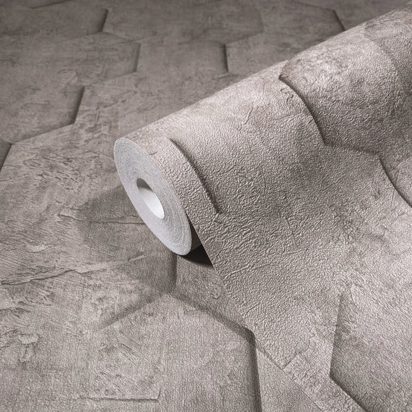 Marburg Loft Superior 34162 A wallpaper roll resting on matching unrolled wallpaper with an embossed geometric pattern and stone-like texture in a neutral tone.
