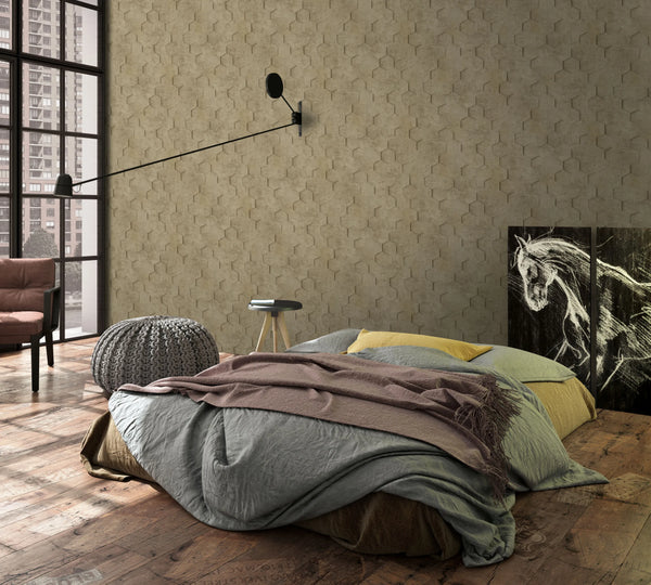 Marburg Loft Superior 34163 Bedroom scene with taupe hexagon-pattern wallpaper. A low bed with layered bedding sits on a rustic wood floor beside a knitted pouf, small stool table, and armchair, with a long swing-arm wall lamp, large window, and a horse art panel leaning against the wall.