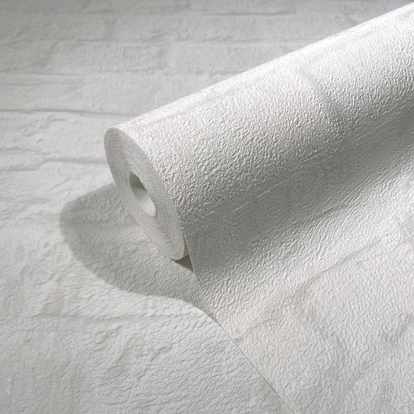 Marburg Loft Superior 34165 A white textured wallpaper roll resting on a matching unrolled sheet, showing an embossed rough surface with a subtle rectangular block pattern.